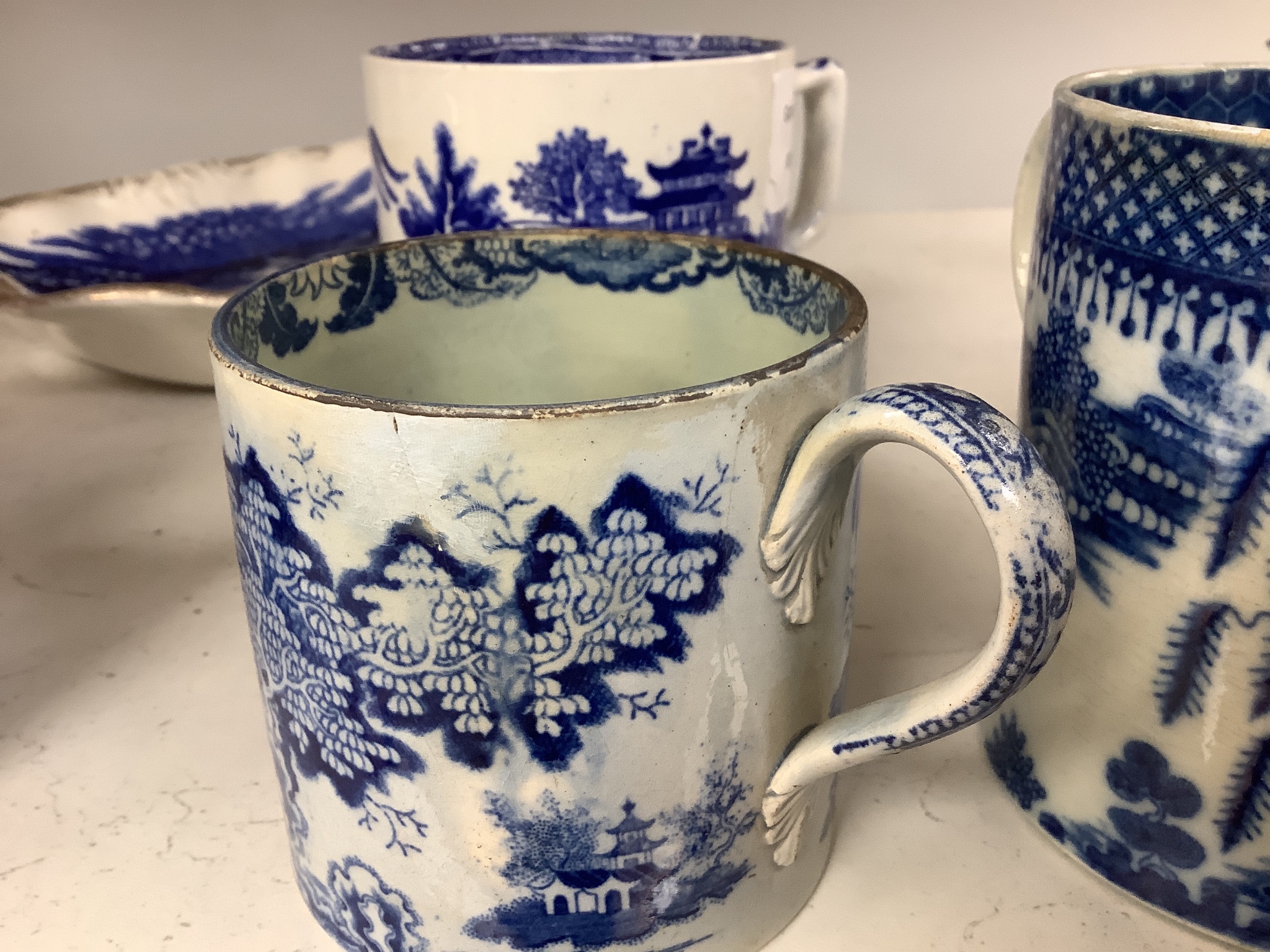 A collection of English blue and white pottery, various dates, comprising a moulded hexagonal teapot and cover, with widow finial, ovoid teapot and cover, lozenge section sugar bowl and cover, with swan finial, circular